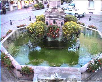 Renaissance fountain in the centre of Eguisheim just below a medieval church dating from the 8th century