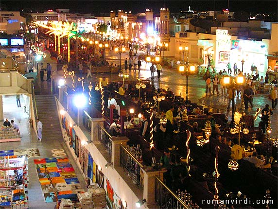 The main shopping street of Sharm, "King of El Bahrain Kingdom Street". It gets rather noisy here at night, with a whole bunch of loudspeakers each trying to drown out it's neighbours. An open air Arabic cafe is at bottom right