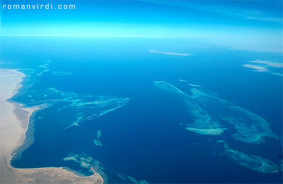 Gulf 
of Suez: Shaab Ali from the air. The land mass to the left is the Sinai.
 The triangular reef is Sha'ab el Deqayeq. The star wreck in this area 
is of course the Thistlegorm, which lies between Deqayeq and the longish
 twin reefs next to it. The right one of the twin reefs is Sha'ab Ali. 
The northernmost of the two small blue islands immediately above Sha'ab 
Ali  is Shag Rock, home to the wreck of the Sarah H. 