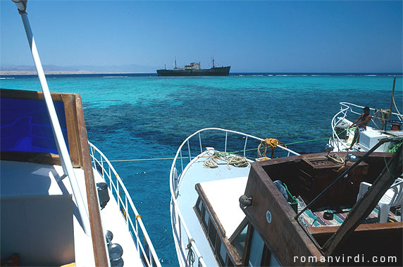 Dive boats
 tied up in the turquoise waters at the straits of Tiran for the lunch 
rest 