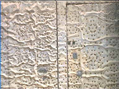 Wrinkled metal door at Javea church