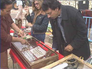 Customer at Jalon flea market pointing to the jewellery she'd like to see