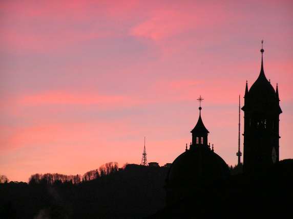 Sunset over the church of Enge and the Üetliberg with it's tower and hotel-restaurant in the distance