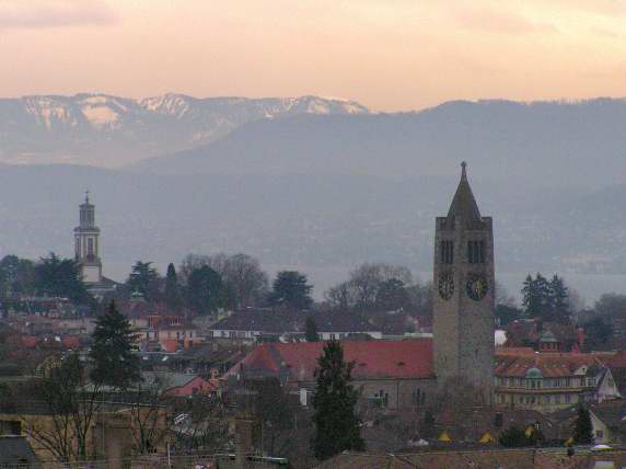 Morning's rosy light over Hottingen church with the mountains of the Albiskette in the background