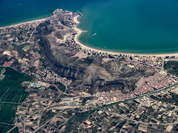 Cullera, Spain. A giant sign proclaims the name on the hills to the right