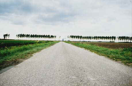 Landscape. On the horizon in the center of the road you can see the cooling tower of a nuclear reactor 