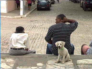 Guys and a dog sitting on the church steps at Laranjeiras, wondering how to start their day
