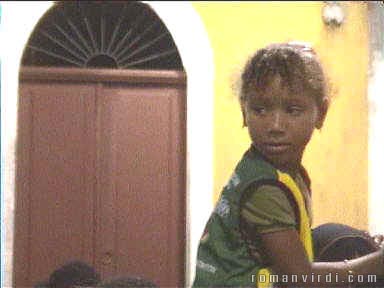 Girl hanging on dad's shoulders watching Carnival