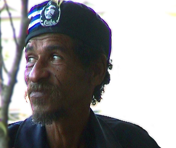 Cuban revolutionary listening critically to live music just outside Inglaterra Hotel Cafe in Havana