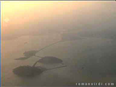 Panama City harbour at sunset. In the foreground you can see the Causeway. The Pacific entrance to the Panama Canal is the waterway just after the causeway, leading to the right.