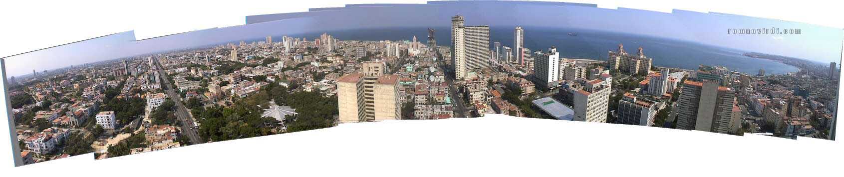 Extreme Panorama View from Che & Fidel's Suite's Balconies at Hotel Havana Libre. The spike on the extreme left is the Jose Marti Memorial. The flat, ribbed, metal pancake is the Coppelia Icecream Parlour. Havana Vieja is to the extreme right