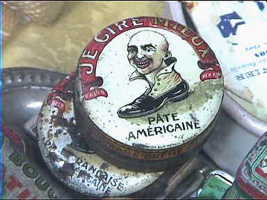 Old shoe polish tins in flea market store