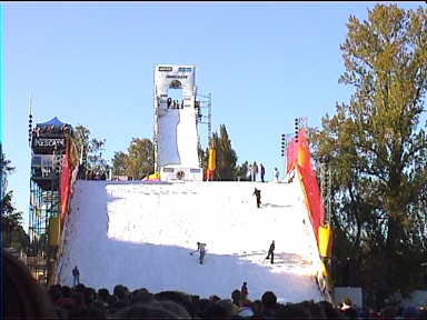 The gigantic ramp for the snowboarders called for loads of helpers flattening the artificial snow to make it suitable to ride on