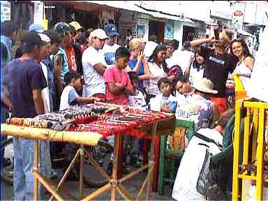 Crowd watching guy (sitting) getting tattoo made in Panajachel