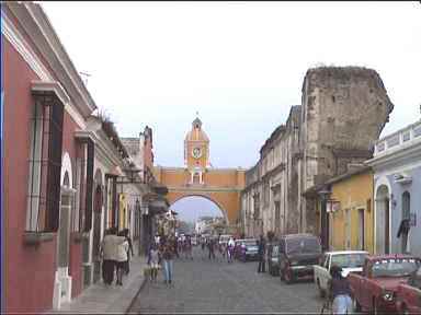 Arco de Santa Catarina through which to view Volcan Agua. On this day there were too many clouds. Look at the old building which survived earthquakes on the right of the street