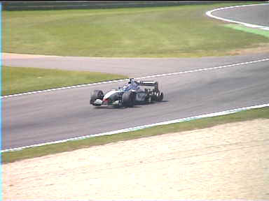 Look at this: Raikkonen's tire tore free from his wheel bit by bit after a puncture. By now, there's no more rubber tire left on his left rear wheel! He's determined to continue and drives to the pit on bare metal, causing his right front wheel to be lifted off the ground...