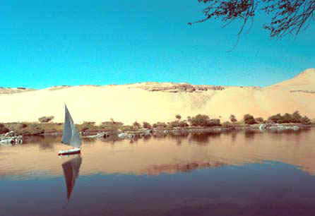 Felucca at Aswan viewed from (Lord) Kitchener's Island. It is said that the English word 'OK' is derived from the initials of 'Old Kitchener' which the man himself used to approve documents. The huge Aswan Dam is nearby, a military zone where photography is strictly prohibited