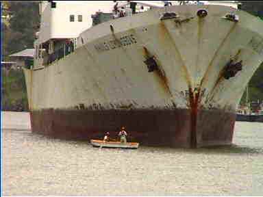 These guys will tie a rope to this freighter so it can be pulled along the canal by locomotives on-shore