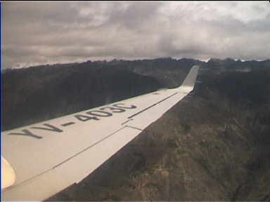 Now flying over stark, dark mountains. Much turbulence, strong winds!!