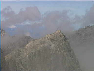 There is an artificial mountain climber at the top of this steep rock