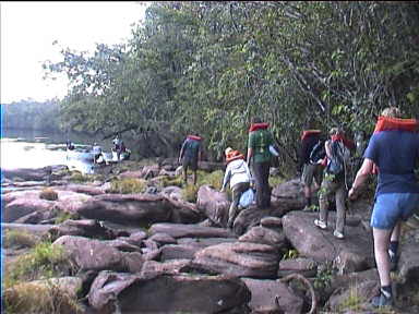 The trip involves frequent walks on land because the water in the river is sometimes too low for everyone to be in the boat