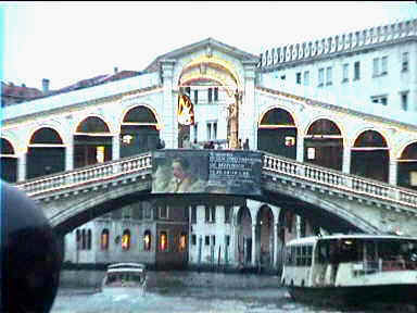 Rialto bridge with the lights on at dusk